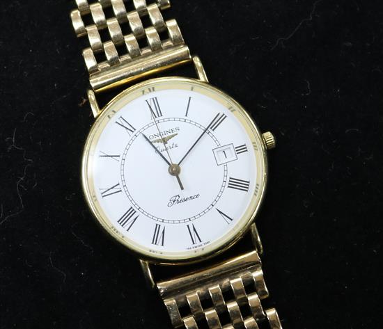 A gentlemans 9ct gold Longines quartz wrist watch on an associated 9ct gold bracelet.